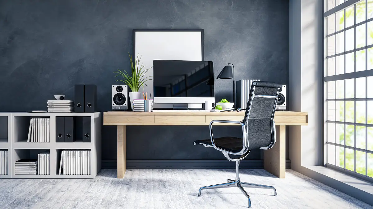 Modern home office with computer and chair.